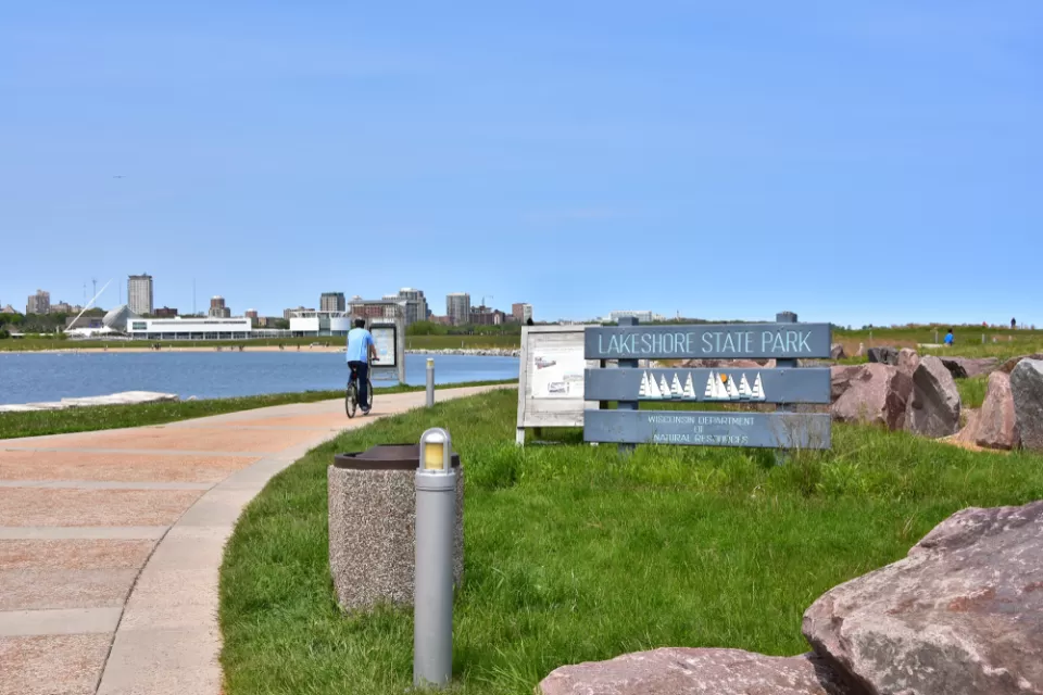 A cyclist on a path in Lakeshore State Park in Milwaukee Wisconsin